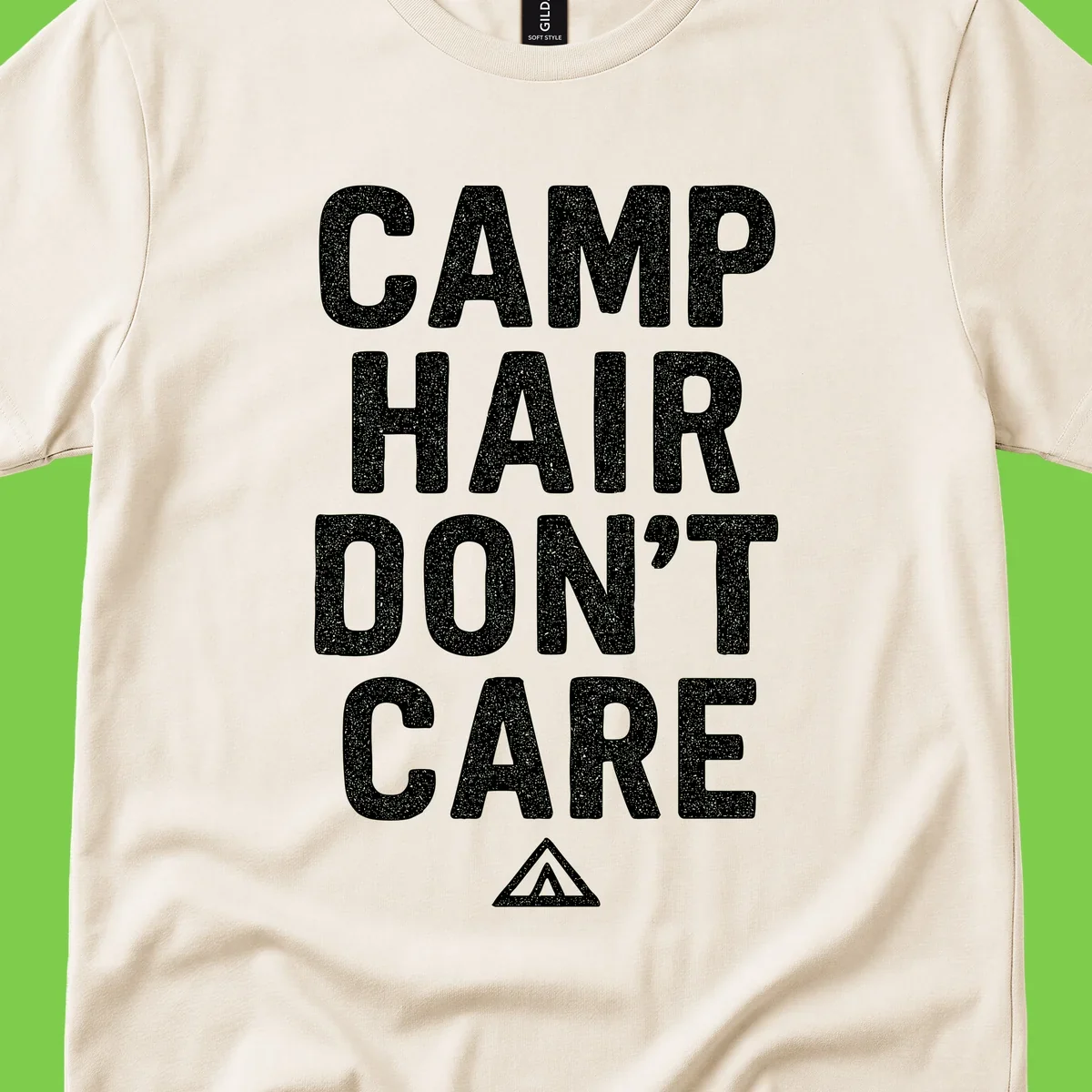 White speckled text reading 'Camp Hair Don't Care' with triangle symbol on gray background