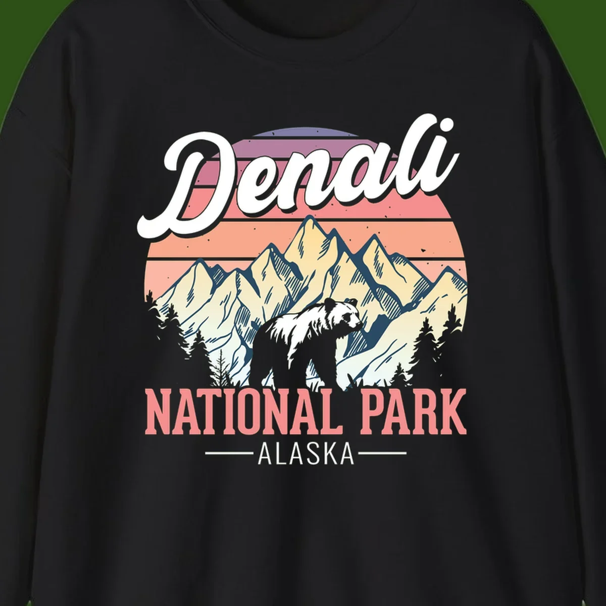 Vintage-style Denali National Park illustration featuring a bear in snowy mountains with retro sunset stripes and evergreen trees
