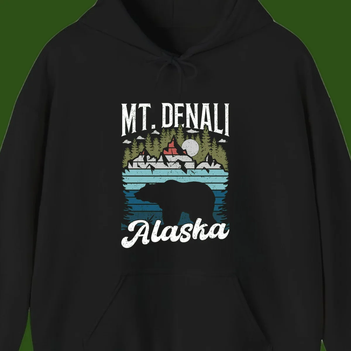 Denali bear Alaska design: layered illustration with silhouetted bear emerging from water, mountain peaks, fortress, forest, and full moon.