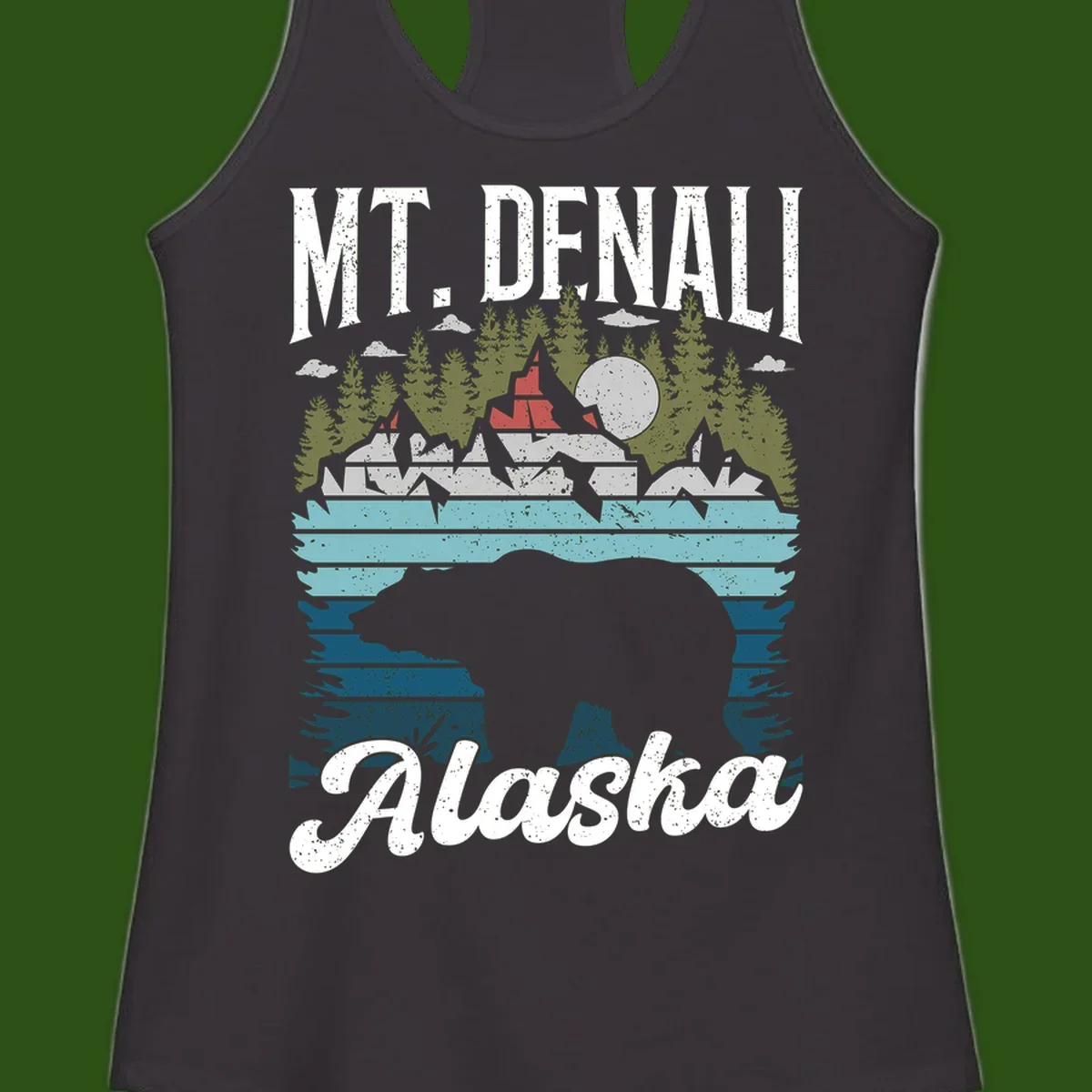 Denali bear Alaska design: layered illustration with silhouetted bear emerging from water, mountain peaks, fortress, forest, and full moon.