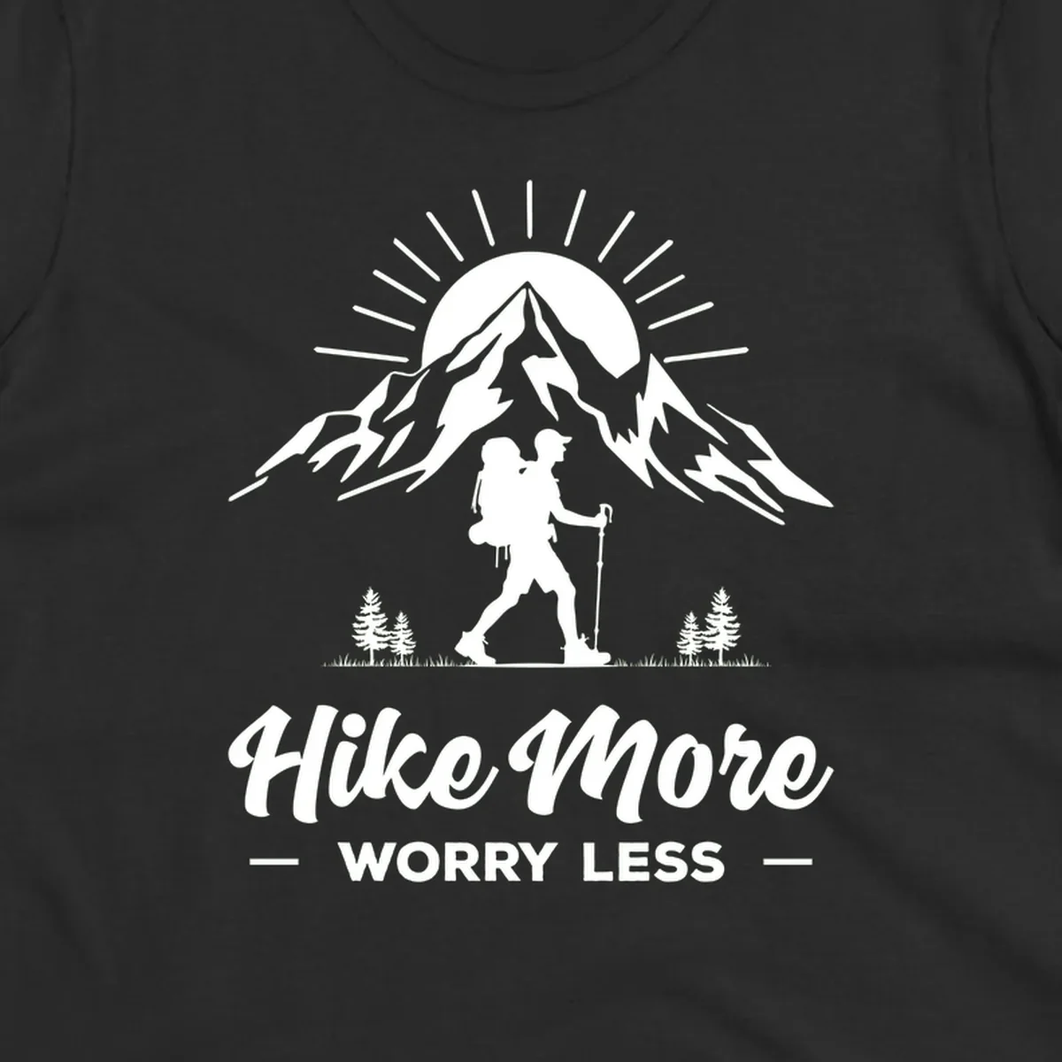 Silhouette of hiker with backpack and poles facing snow-capped mountain with radiating sun, evergreen trees below, text reads 'Hike More Worry Less'