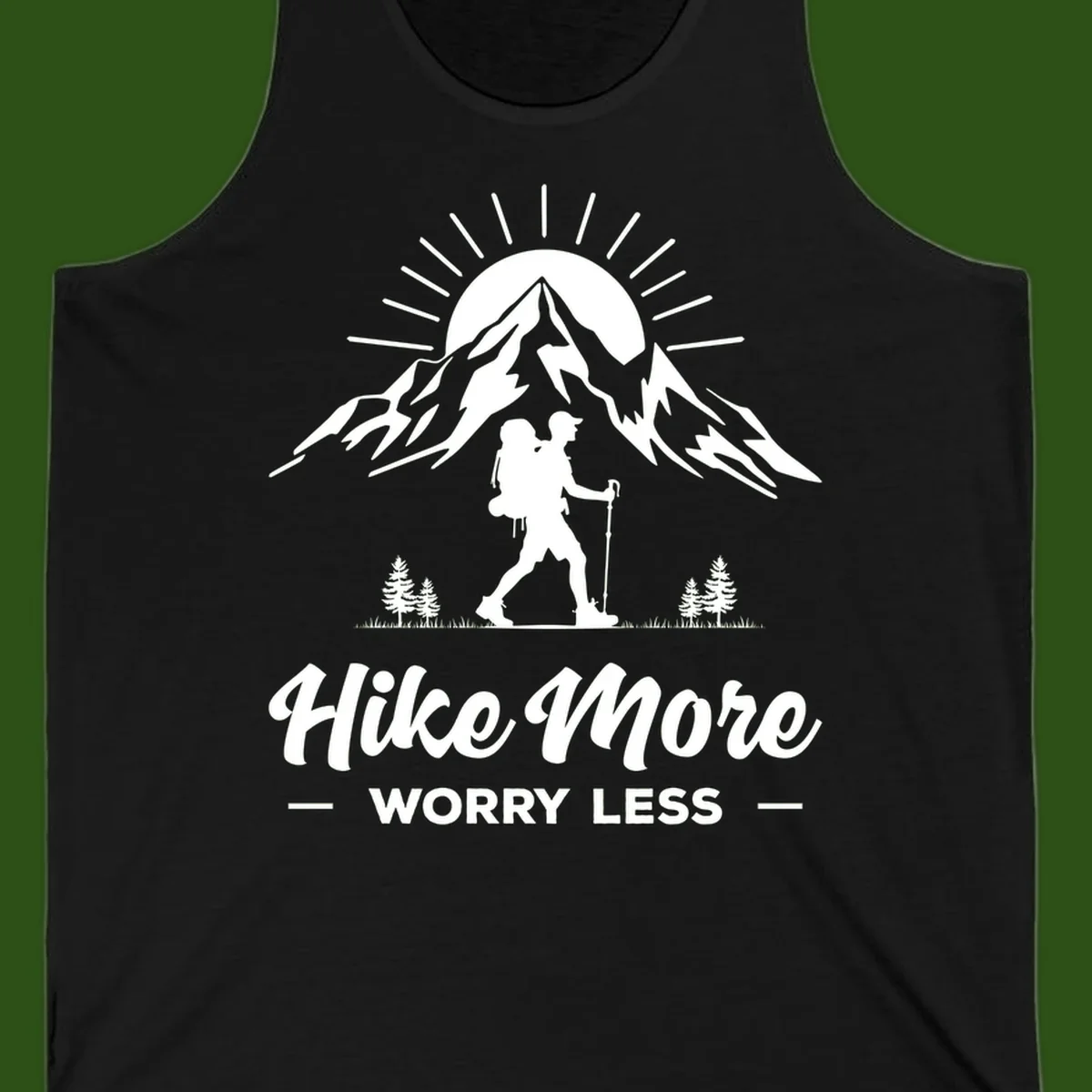 Silhouette of hiker with backpack and poles facing snow-capped mountain with radiating sun, evergreen trees below, text reads 'Hike More Worry Less'