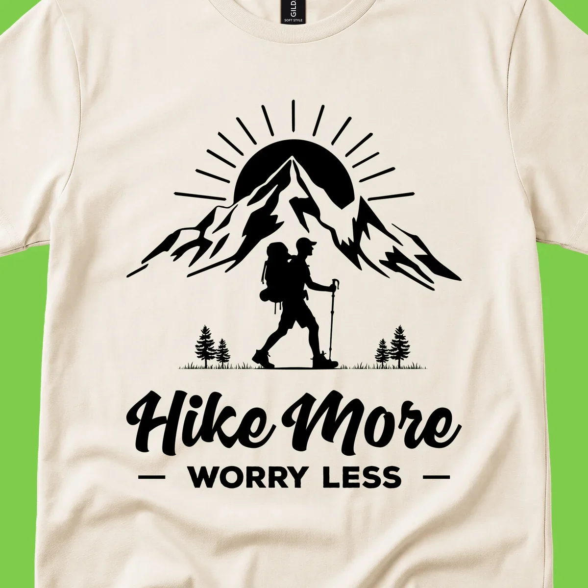 Silhouette of hiker with backpack and poles facing snow-capped mountain with radiating sun, evergreen trees below, text reads 'Hike More Worry Less'