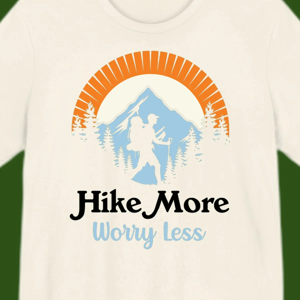 Hike more worry less badge design with silhouetted hiker, mountain peak, and evergreen forest in circular composition.