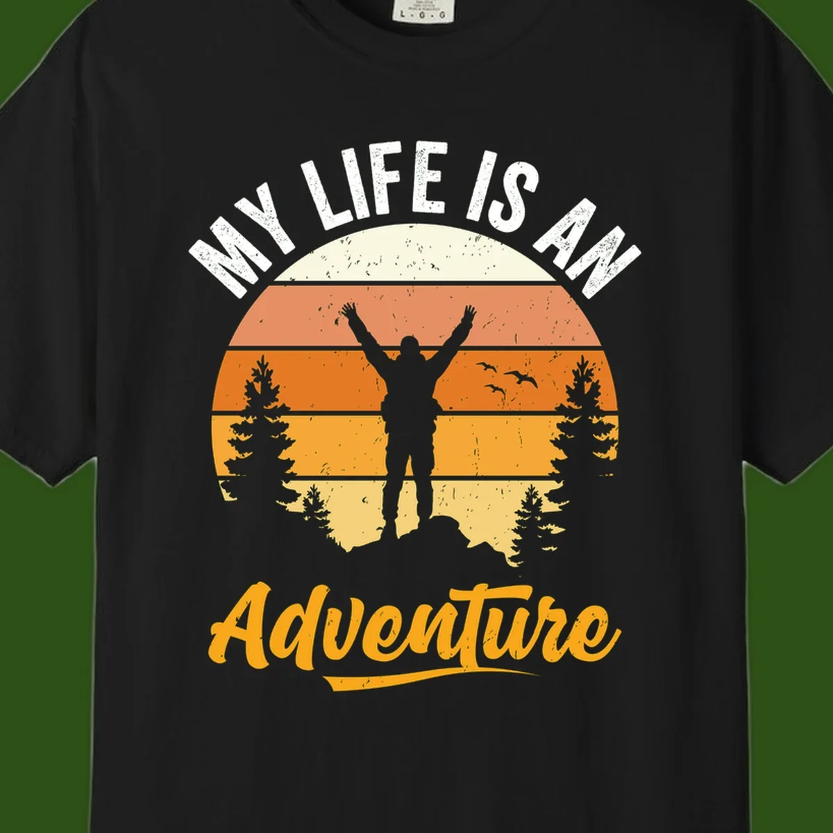 Retro sunset illustration with silhouette of person celebrating arms raised, evergreen trees and mountains, text 'My Life Is An Adventure'