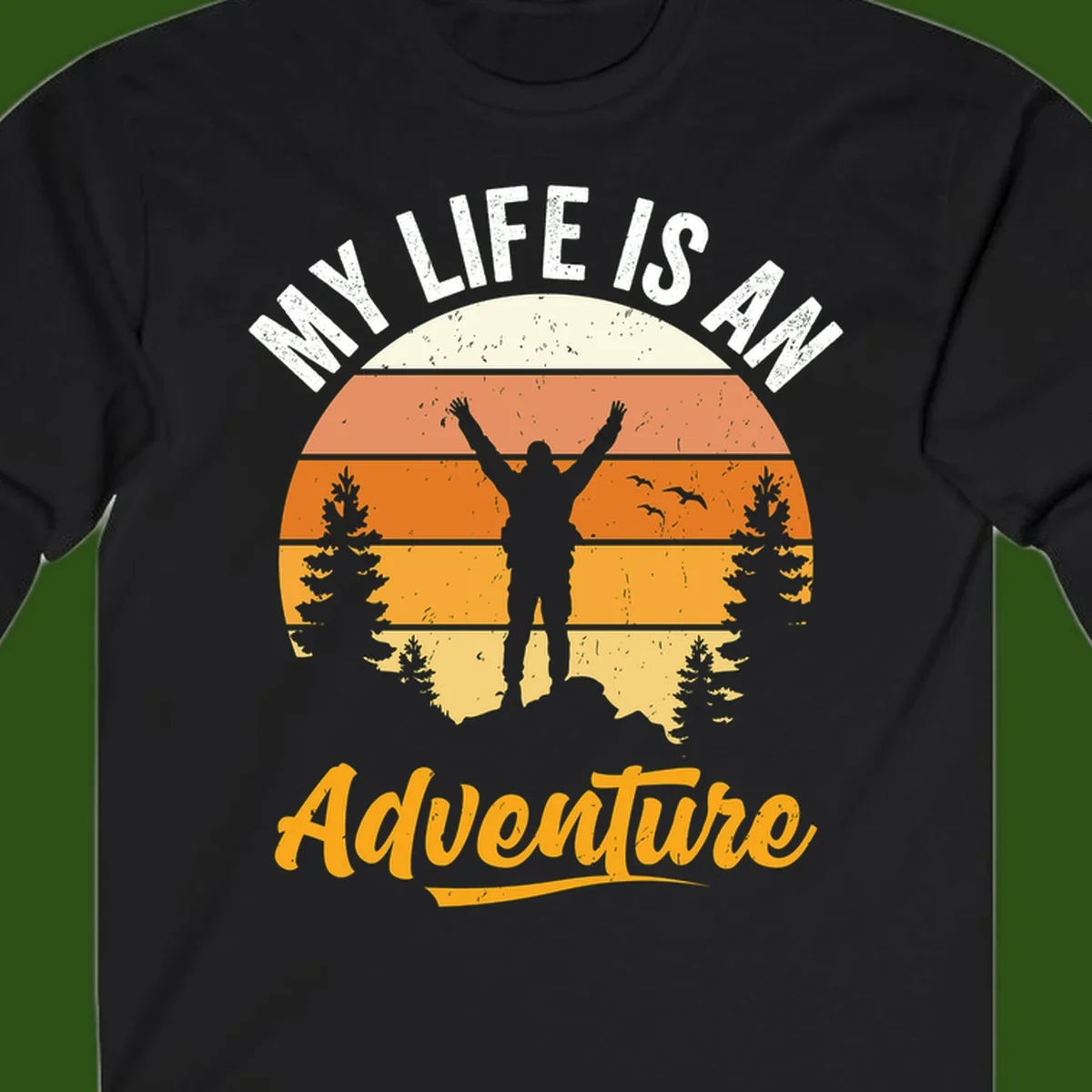 Retro sunset illustration with silhouette of person celebrating arms raised, evergreen trees and mountains, text 'My Life Is An Adventure'