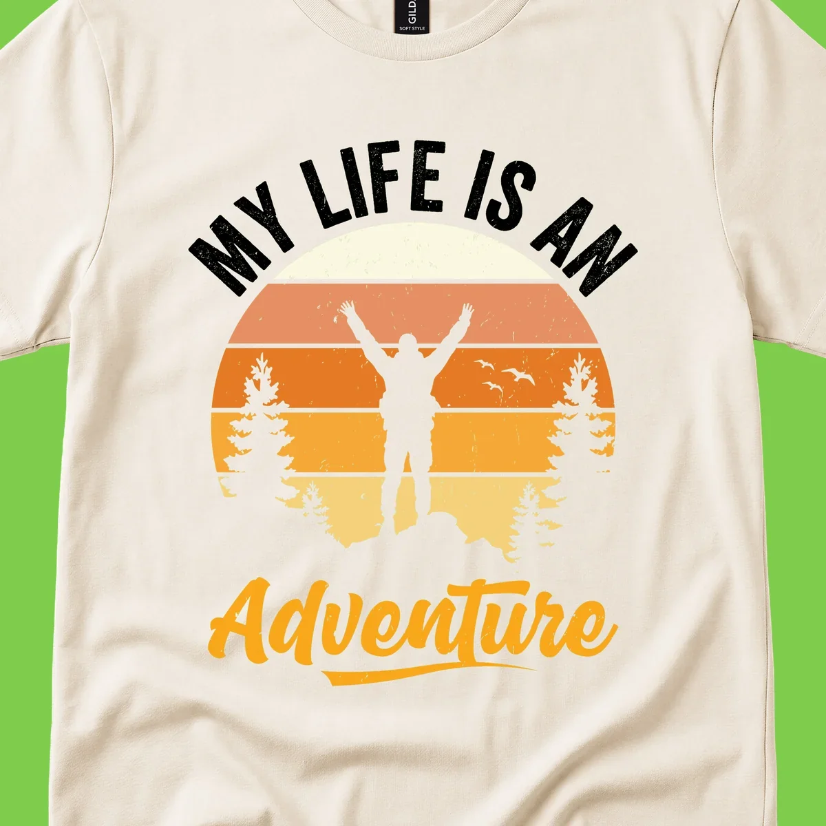 Retro sunset illustration with silhouette of person celebrating arms raised, evergreen trees and mountains, text 'My Life Is An Adventure'