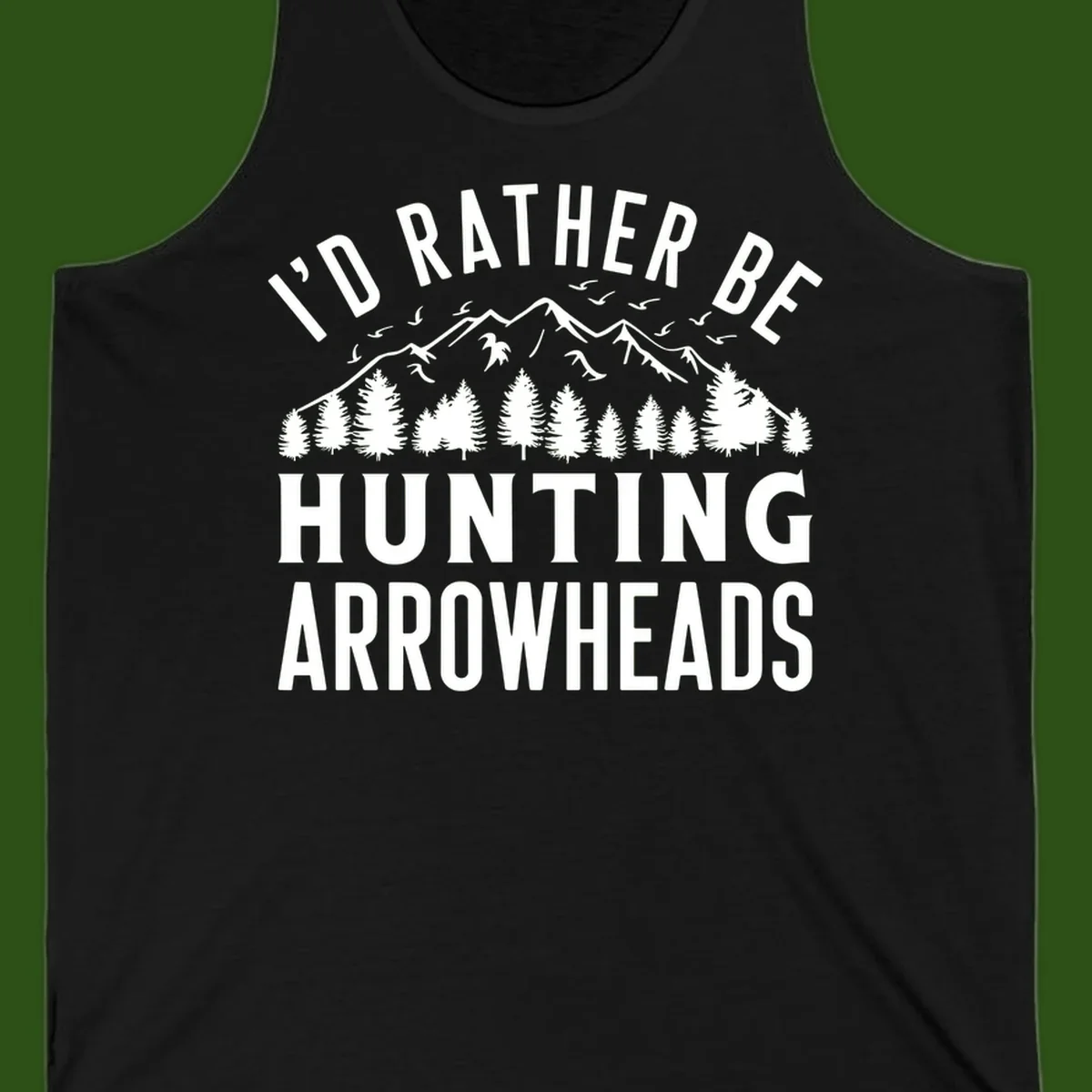 Mountain landscape with evergreen trees and birds, white text reading 'I'd Rather Be Hunting Arrowheads' on gray background