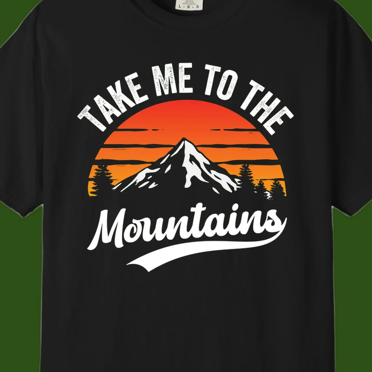 Vintage-style illustration of snow-capped mountain with sunset stripes and evergreen trees, text reading 'Take Me To The Mountains'