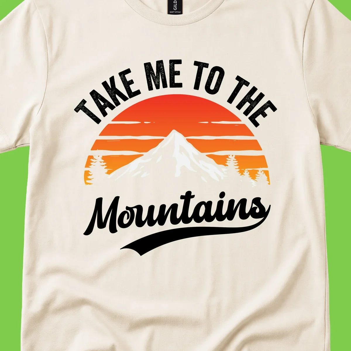Vintage-style illustration of snow-capped mountain with sunset stripes and evergreen trees, text reading 'Take Me To The Mountains'