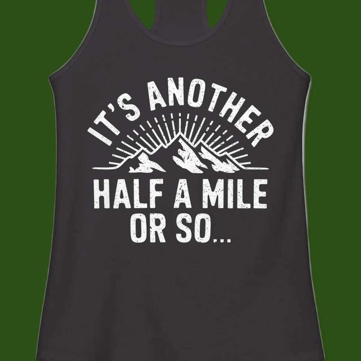 Retro distressed design with mountain peaks and sun rays, text reads 'It's Another Half A Mile Or So' - humorous hiking and camping artwork