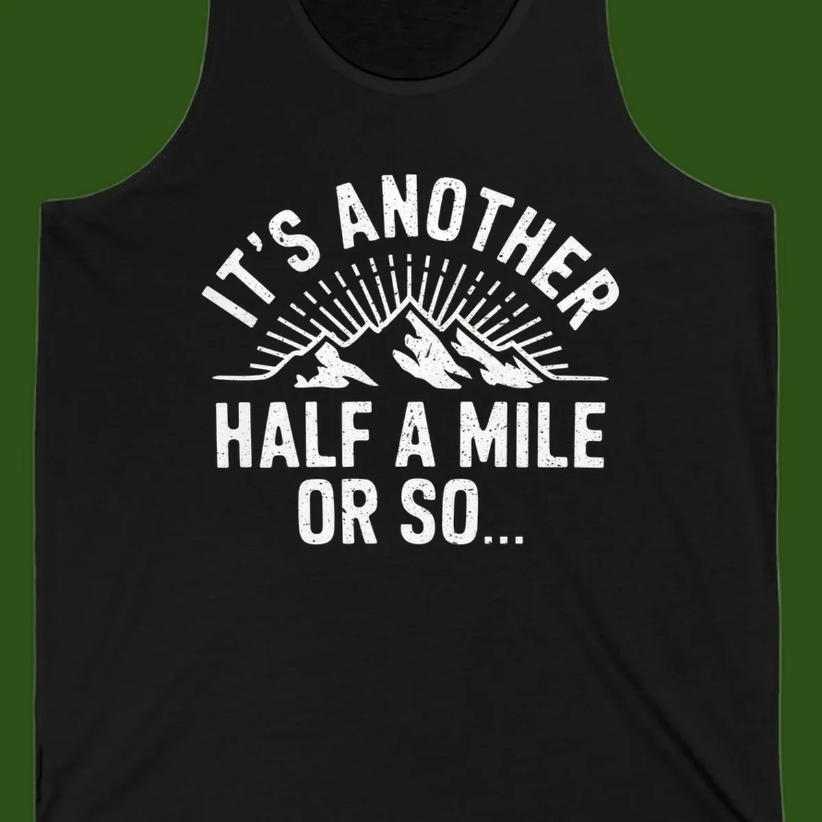 Retro distressed design with mountain peaks and sun rays, text reads 'It's Another Half A Mile Or So' - humorous hiking and camping artwork