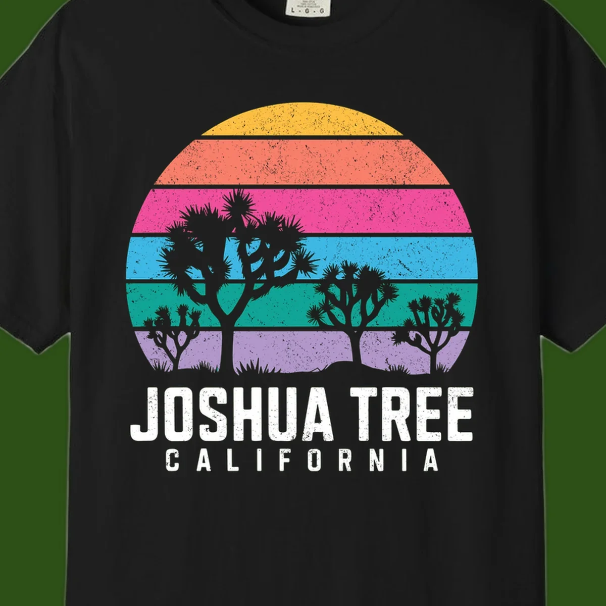 Joshua tree desert stripes design with silhouetted trees across rainbow horizontal color bands and distressed texture.