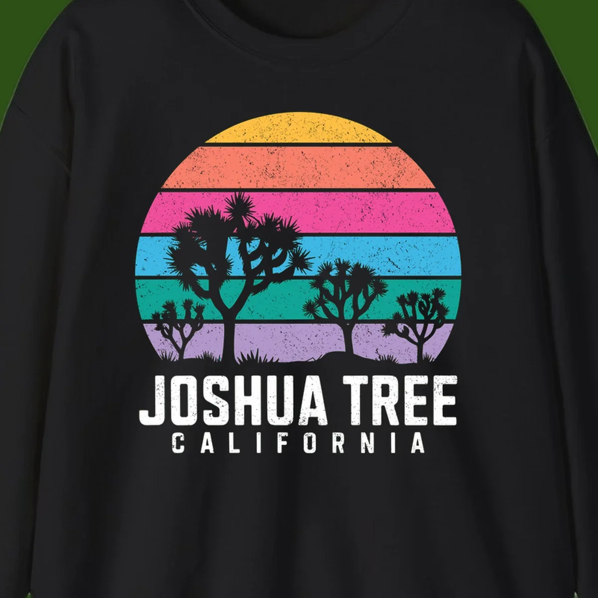 Joshua tree desert stripes design with silhouetted trees across rainbow horizontal color bands and distressed texture.