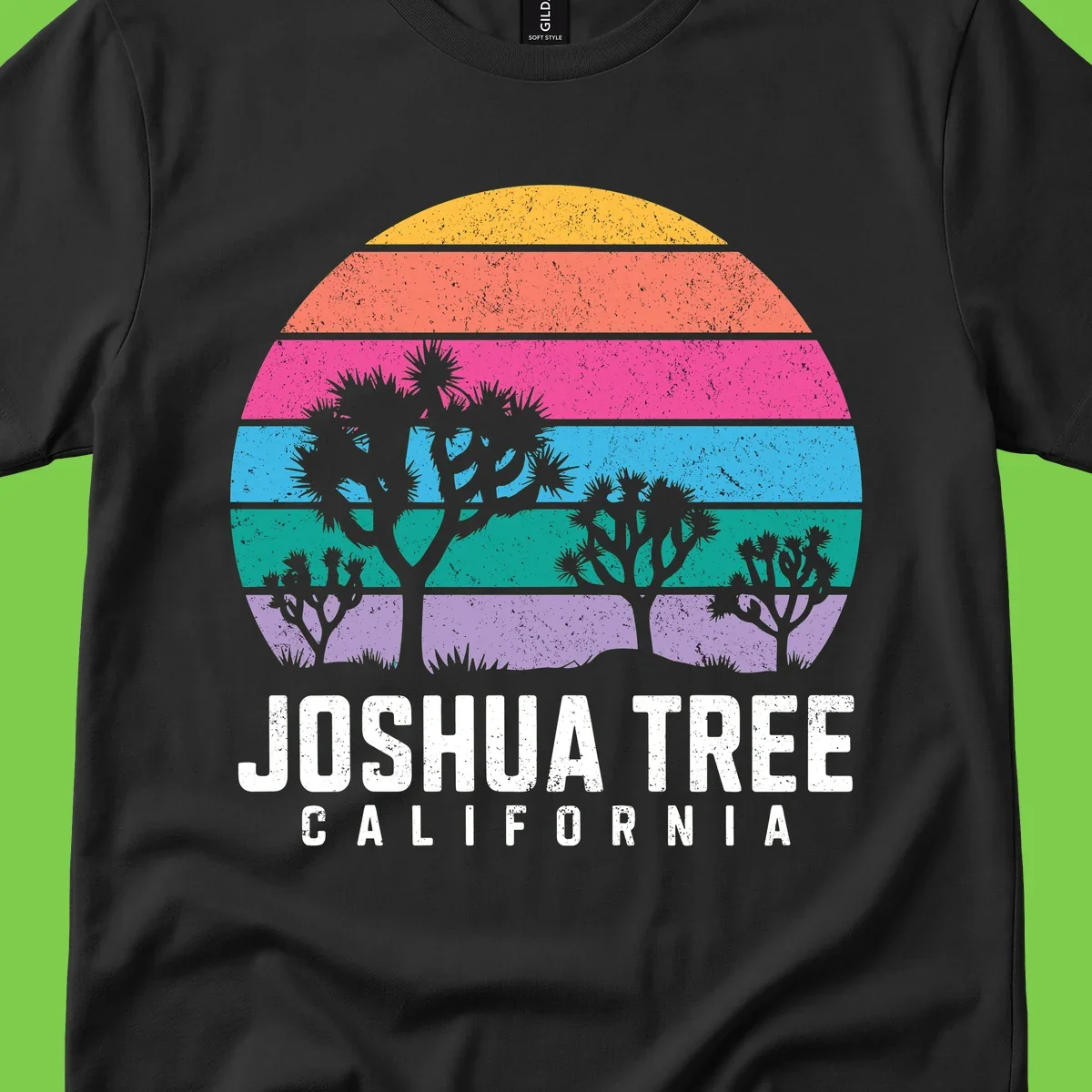 Joshua tree desert stripes design with silhouetted trees across rainbow horizontal color bands and distressed texture.