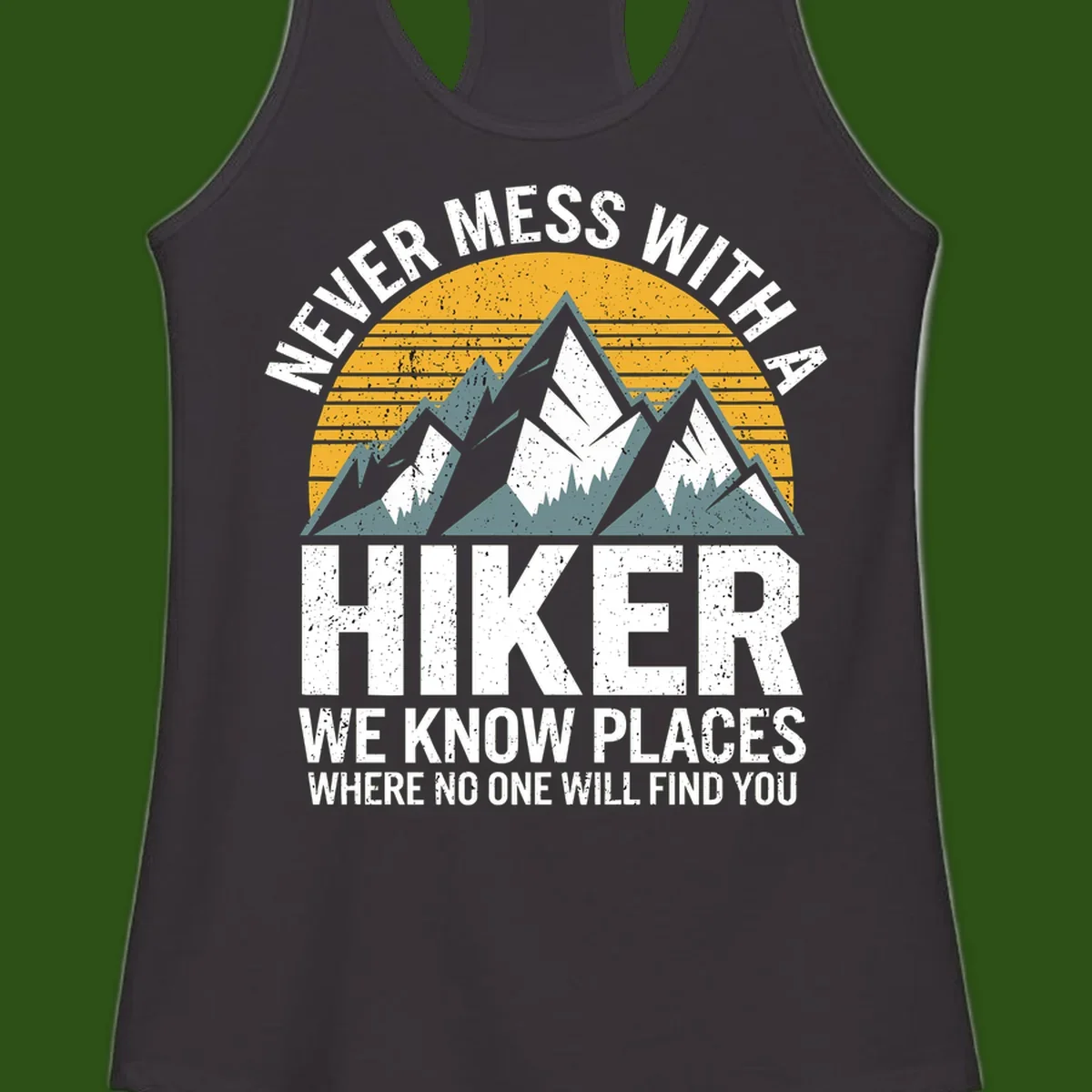 Vintage-style design with snow-capped mountains and forest silhouette against striped sunset, text reads 'Never Mess With A Hiker We Know Places Where No One Will Find You'