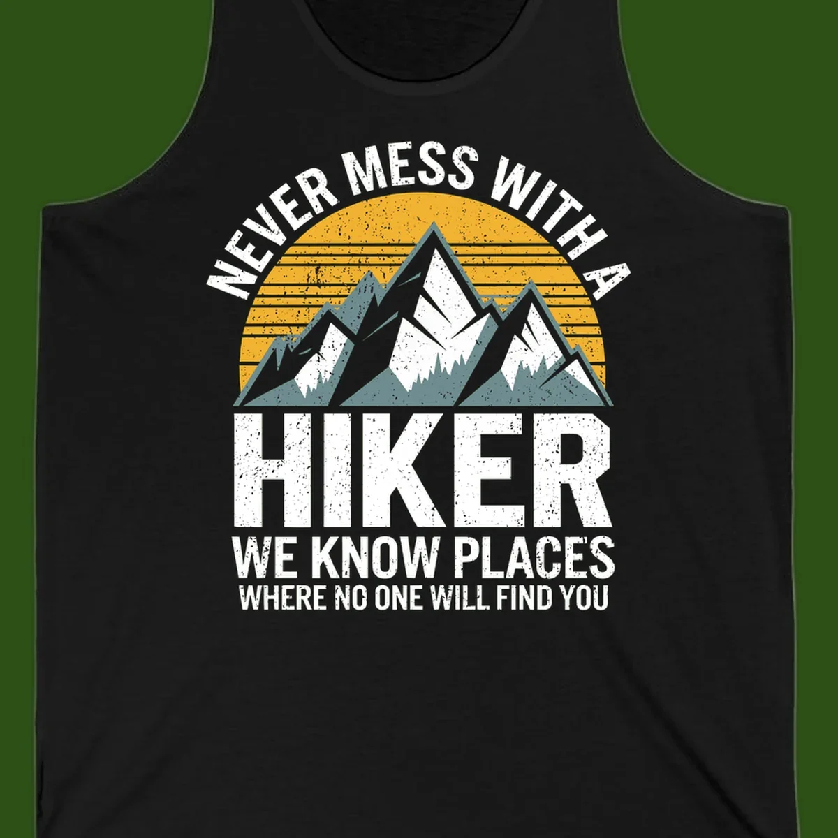 Vintage-style design with snow-capped mountains and forest silhouette against striped sunset, text reads 'Never Mess With A Hiker We Know Places Where No One Will Find You'
