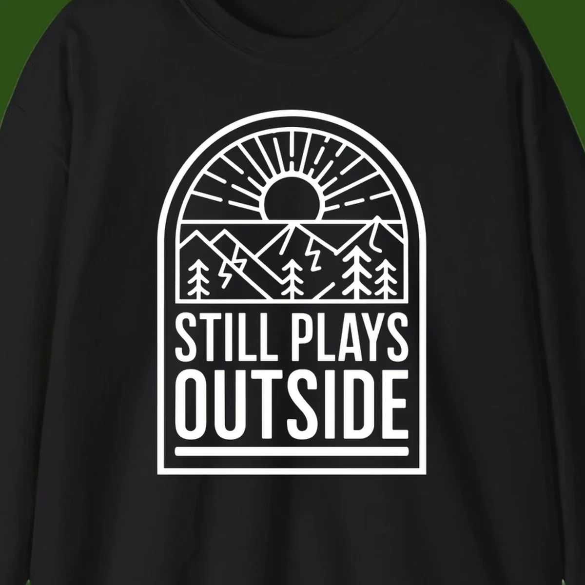 Still Plays Outside badge design featuring mountains, sun, pine trees, and lightning bolt in minimalist line art style