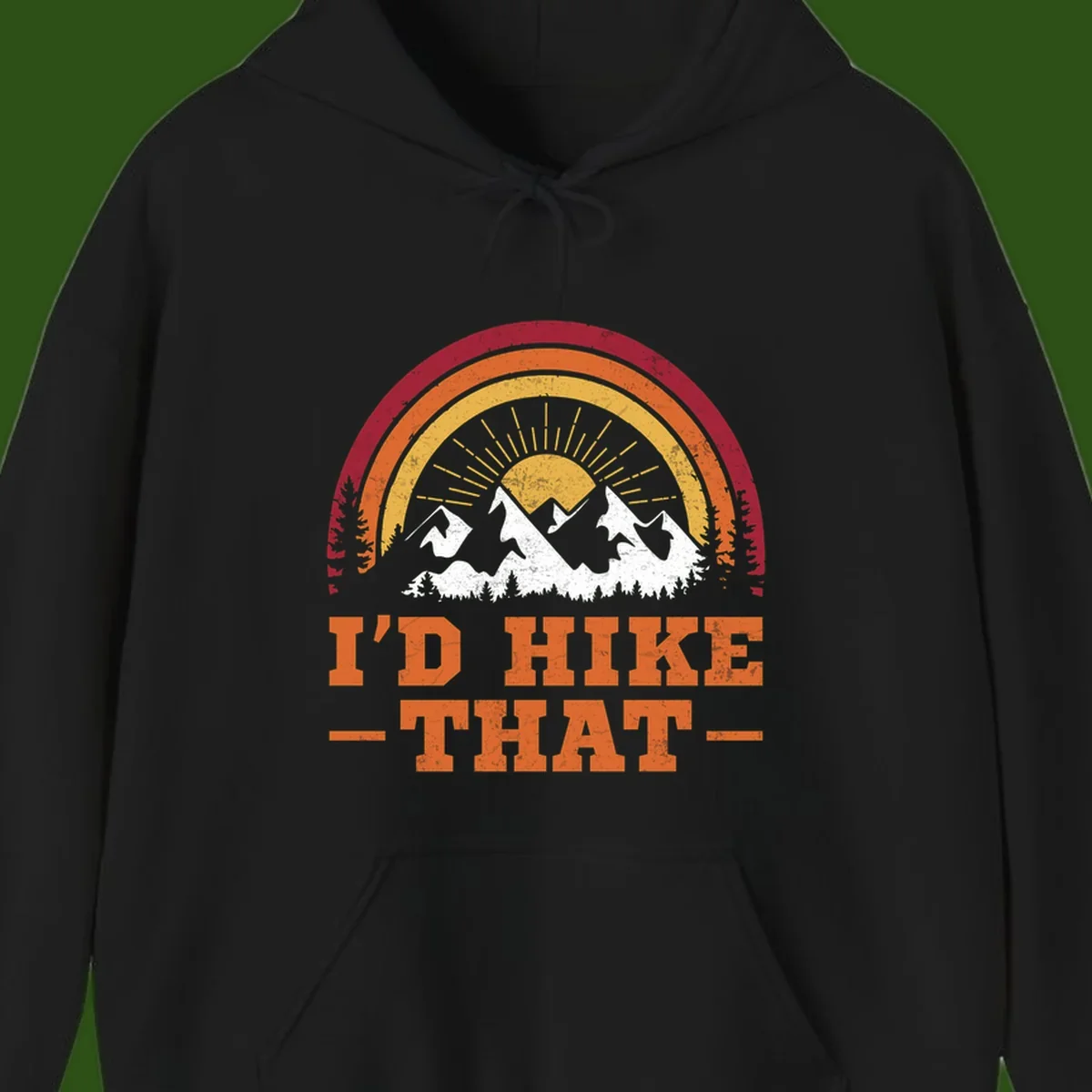 Vintage badge design with snow-capped mountains, evergreen trees, golden sun rays, and text reading 'I'd Hike That' in retro style