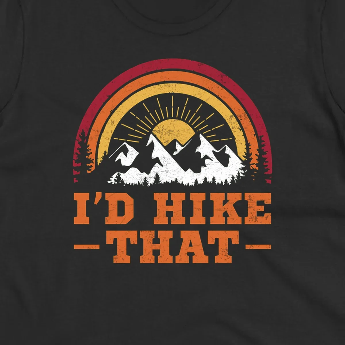 Vintage badge design with snow-capped mountains, evergreen trees, golden sun rays, and text reading 'I'd Hike That' in retro style