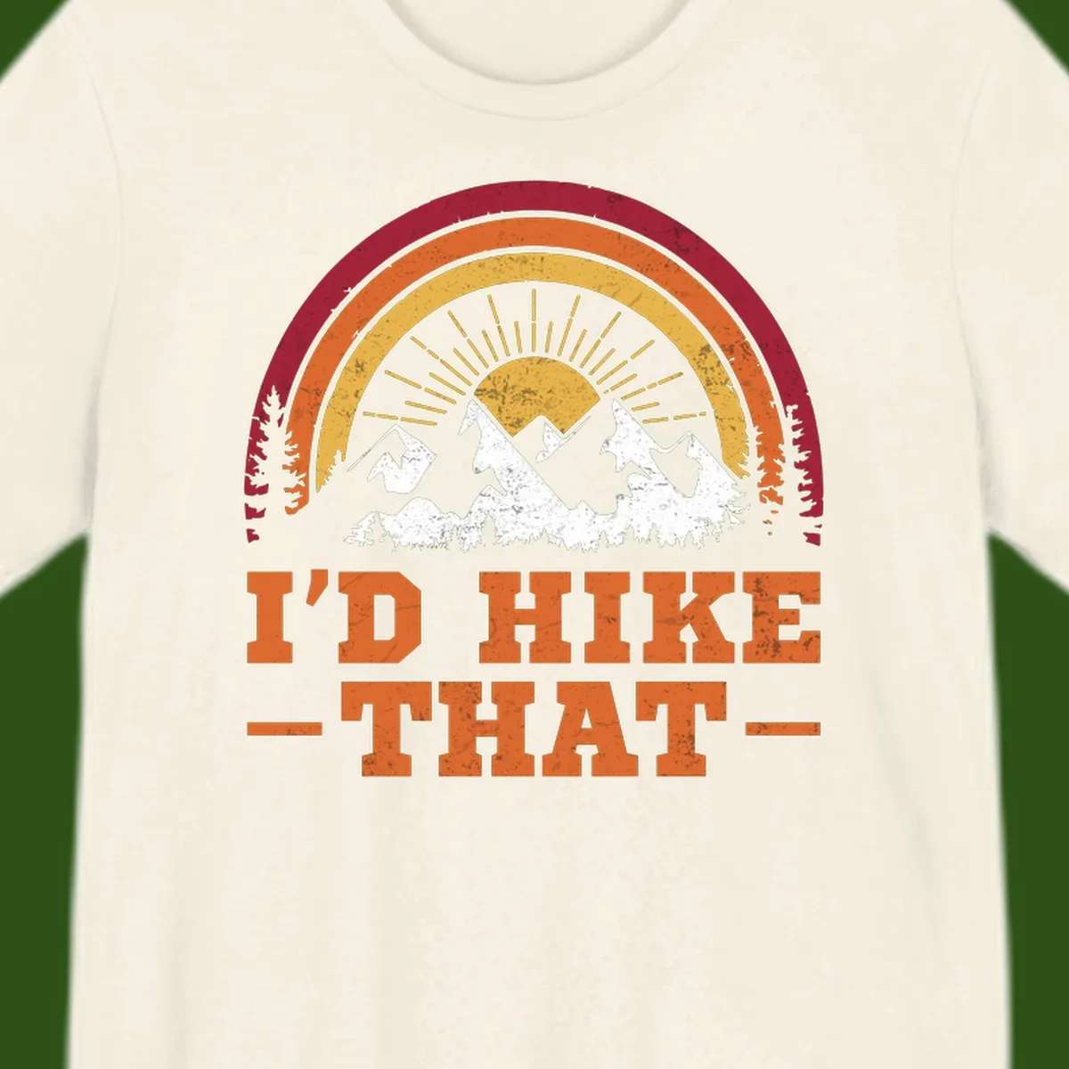 Vintage badge design with snow-capped mountains, evergreen trees, golden sun rays, and text reading 'I'd Hike That' in retro style
