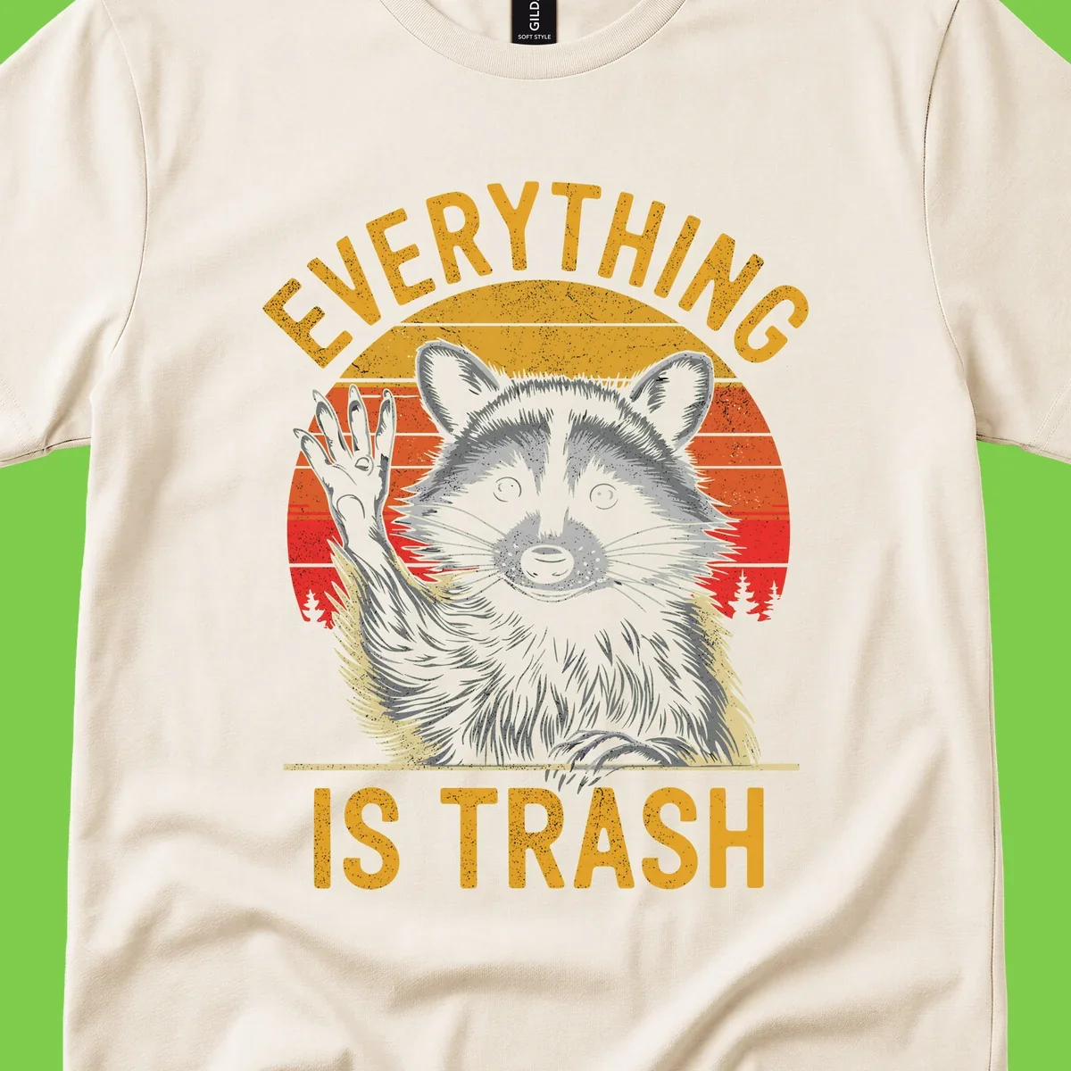 Vintage-style illustration of a raccoon with raised paw against retro sunset stripes, text reading 'Everything Is Trash' in distressed gold lettering