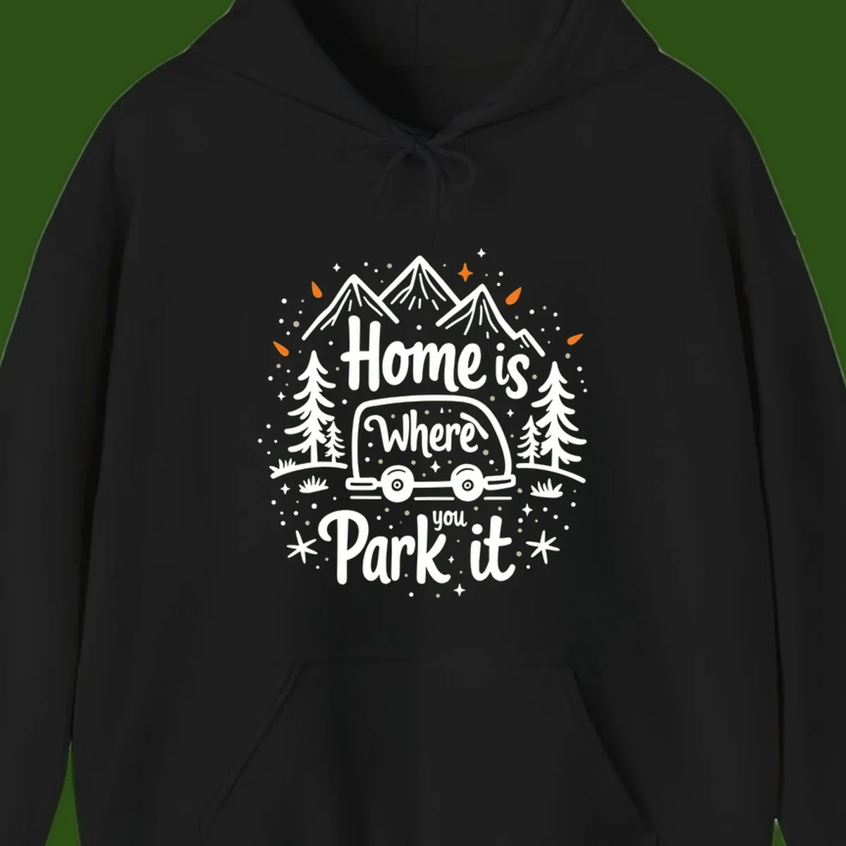 Illustrated winter camping scene with travel trailer, mountains, trees, and snowflakes with text 'Home is Where you Park it'