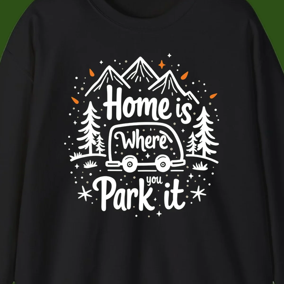 Illustrated winter camping scene with travel trailer, mountains, trees, and snowflakes with text 'Home is Where you Park it'