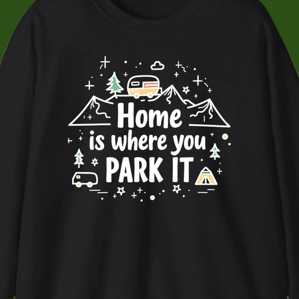 Illustrated design with vintage travel trailer parked on mountain road, evergreen trees, tent, and text reading 'Home is where you park it' on gray background.