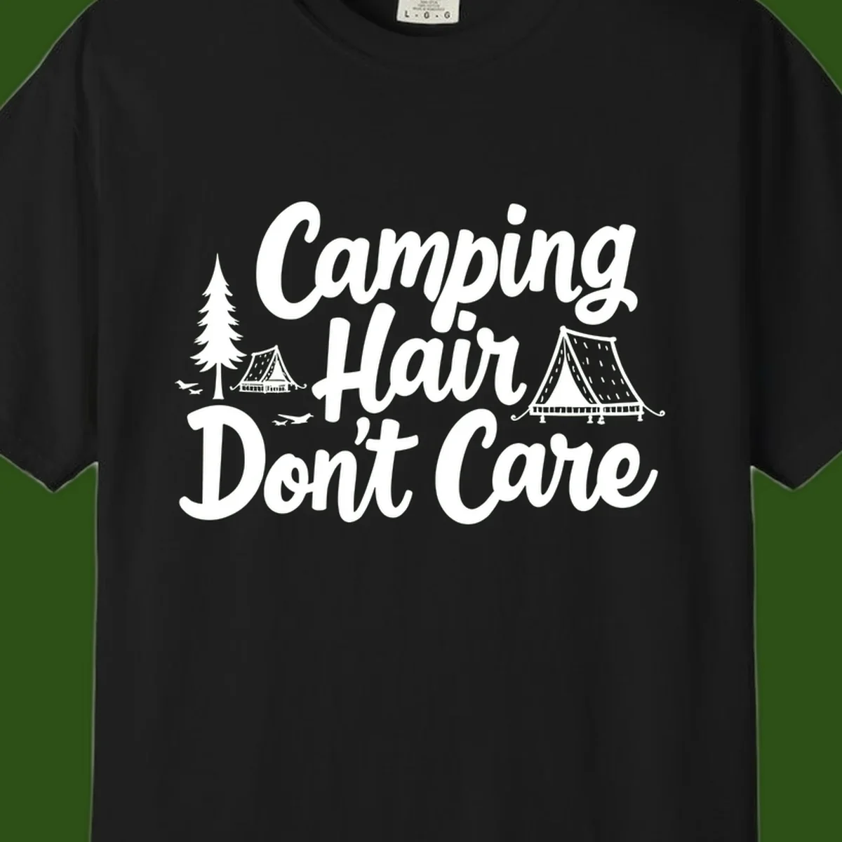 White text reading 'Camping Hair Don't Care' with illustrated tent and evergreen tree designs on gray background