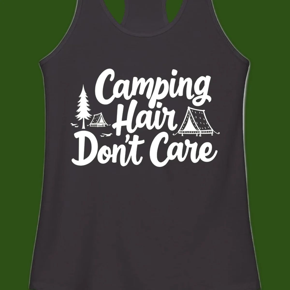 White text reading 'Camping Hair Don't Care' with illustrated tent and evergreen tree designs on gray background