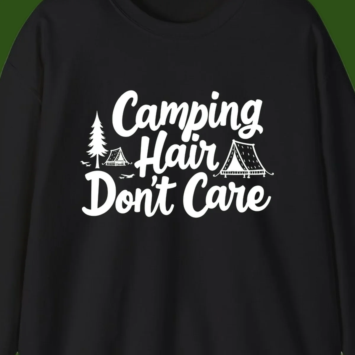 White text reading 'Camping Hair Don't Care' with illustrated tent and evergreen tree designs on gray background