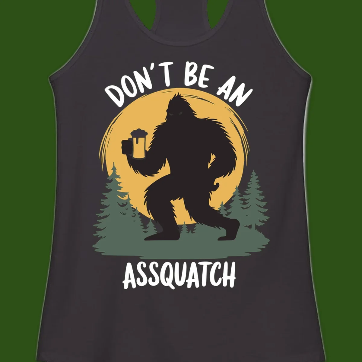 Black silhouette of Bigfoot holding a beer mug under a full moon with pine trees, text reads don't be an assquatch