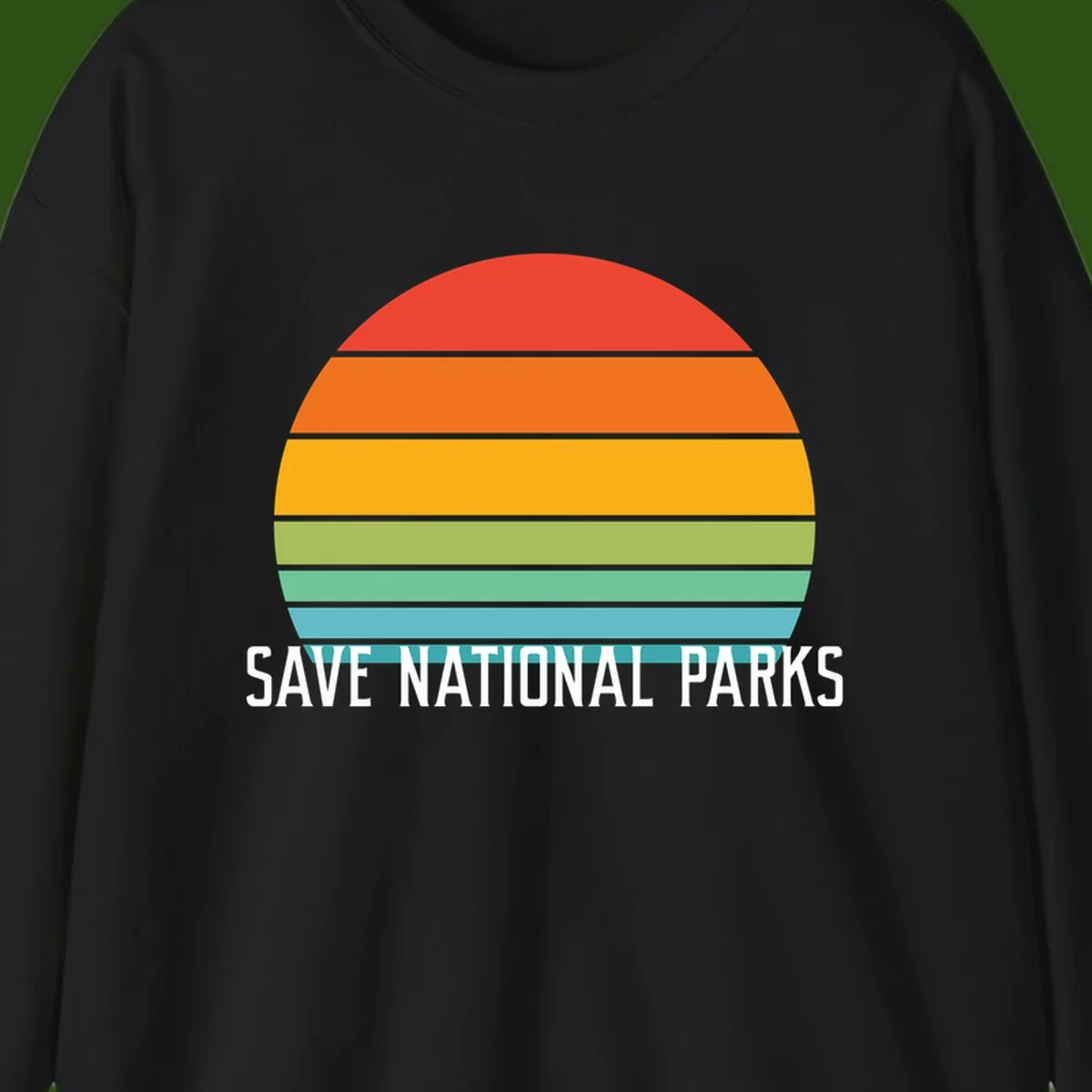 Retro layered sunset design with save national parks text in white, featuring horizontal color bands in red, orange, yellow, green, and blue.