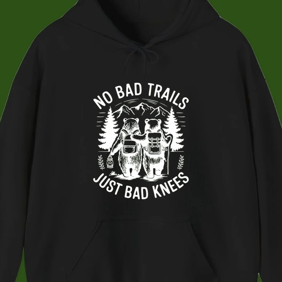Two cartoon bears with backpacks hiking in mountains with text 'No Bad Trails Just Bad Knees' - humorous outdoor camping design