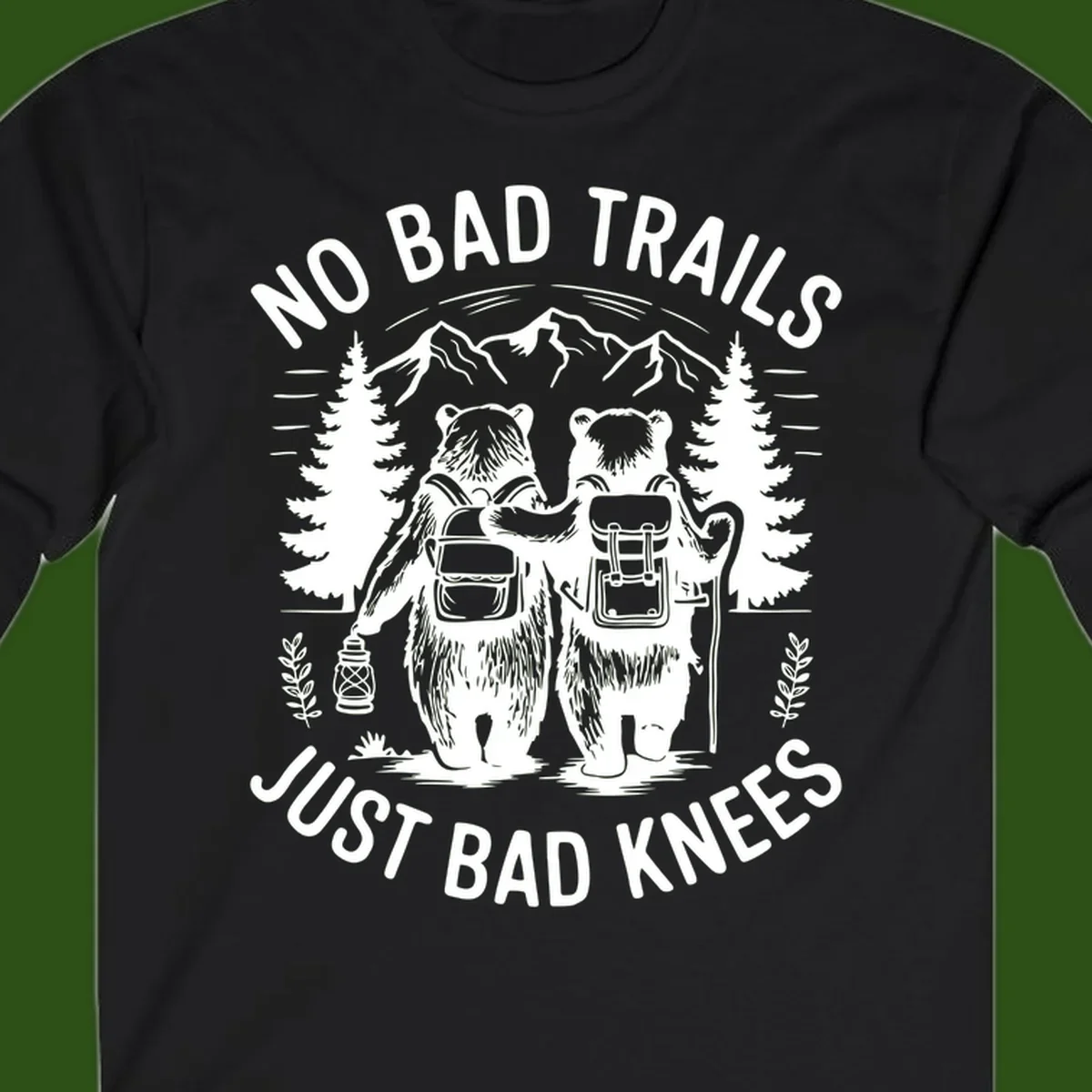 Two cartoon bears with backpacks hiking in mountains with text 'No Bad Trails Just Bad Knees' - humorous outdoor camping design