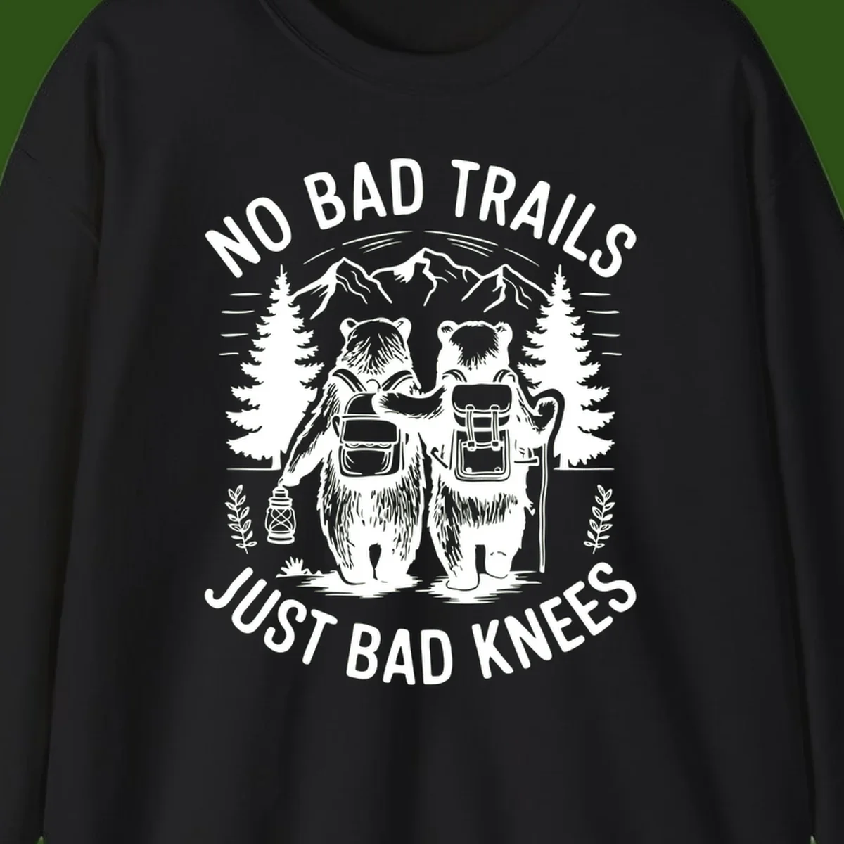 Two cartoon bears with backpacks hiking in mountains with text 'No Bad Trails Just Bad Knees' - humorous outdoor camping design
