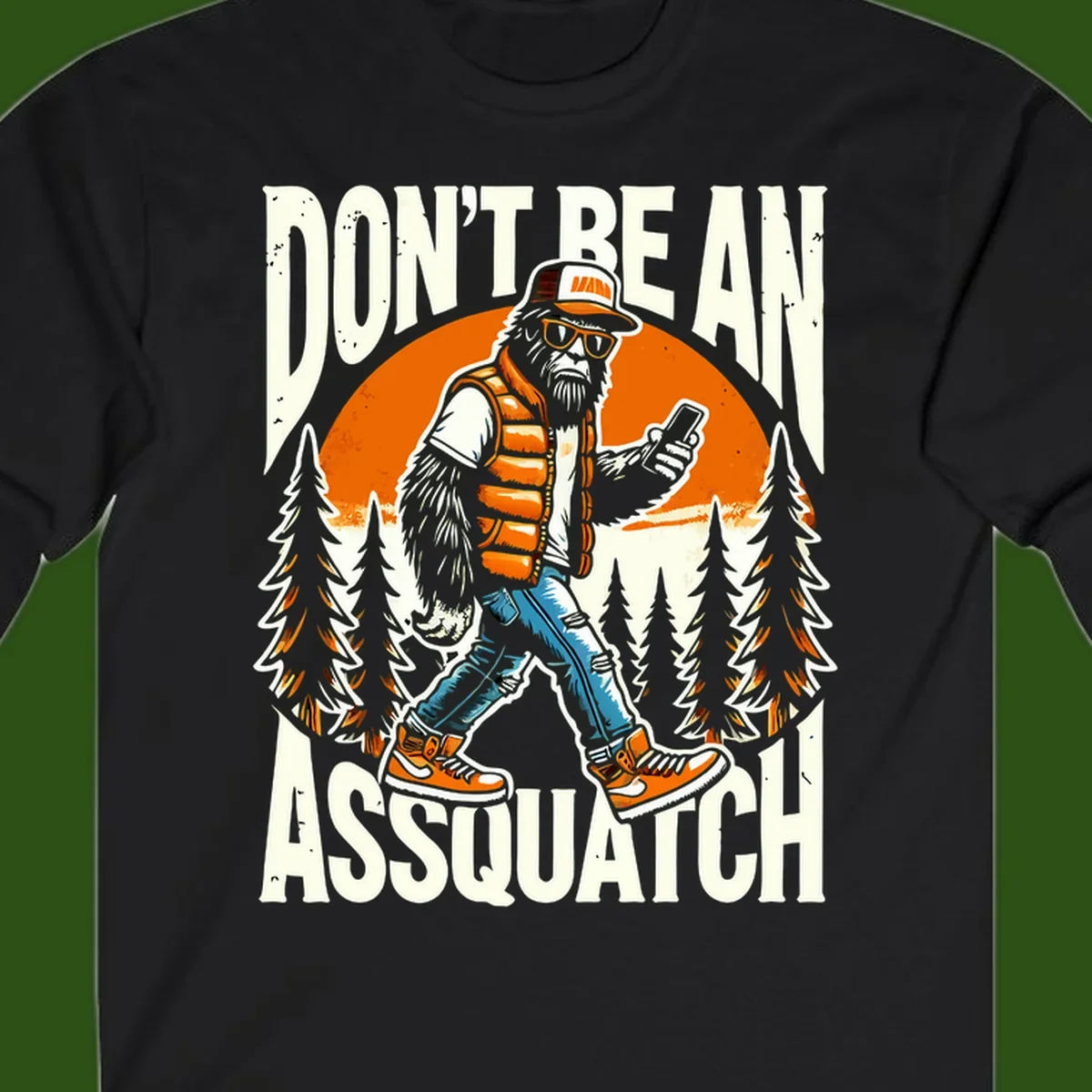 Cartoon sasquatch in hiking gear with backpack and smartphone, 'Don't Be An Assquatch' text, forest and orange sun background.