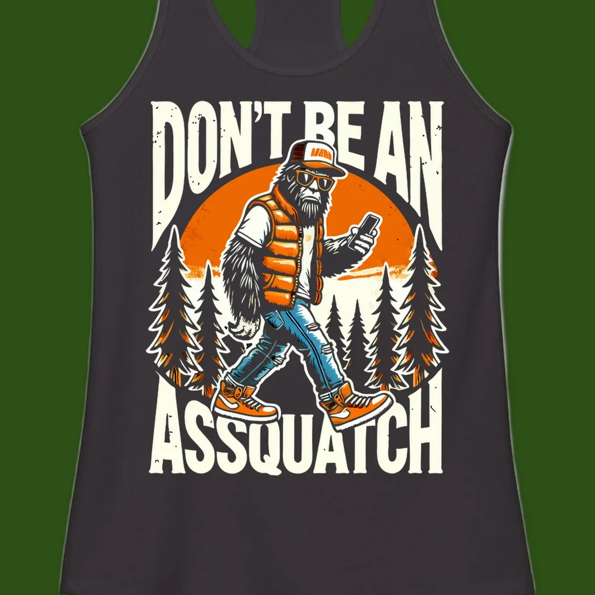 Cartoon sasquatch in hiking gear with backpack and smartphone, 'Don't Be An Assquatch' text, forest and orange sun background.