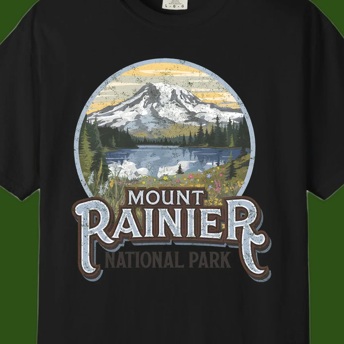 Vintage Mount Rainier National Park badge design with snow-capped peak, alpine lake, evergreen forest, and wildflowers on distressed background