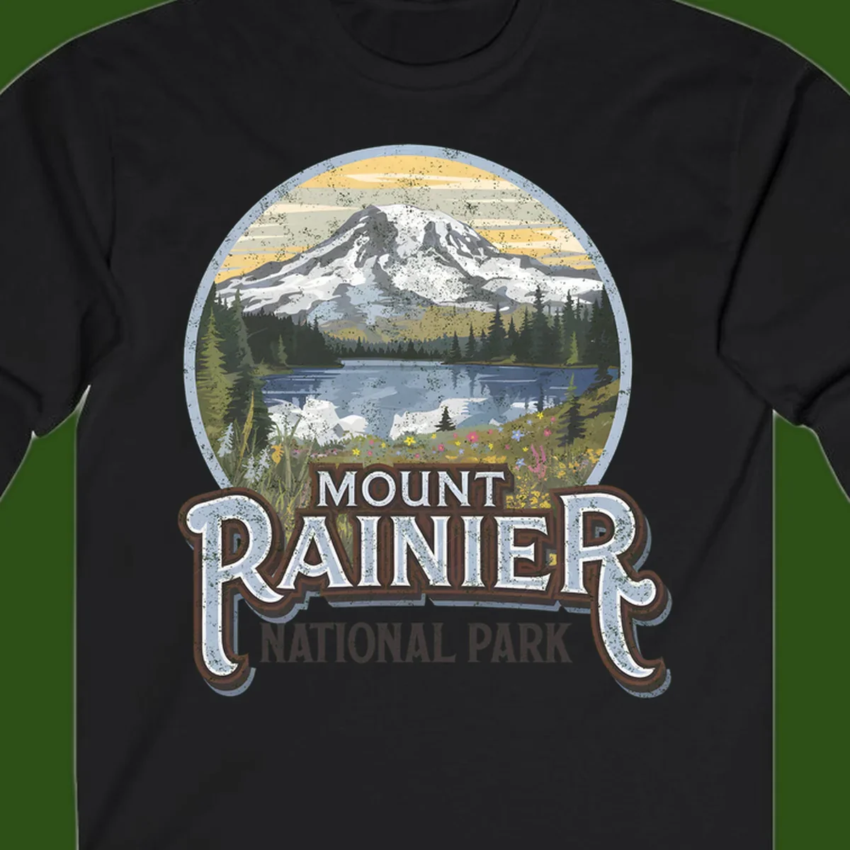 Vintage Mount Rainier National Park badge design with snow-capped peak, alpine lake, evergreen forest, and wildflowers on distressed background
