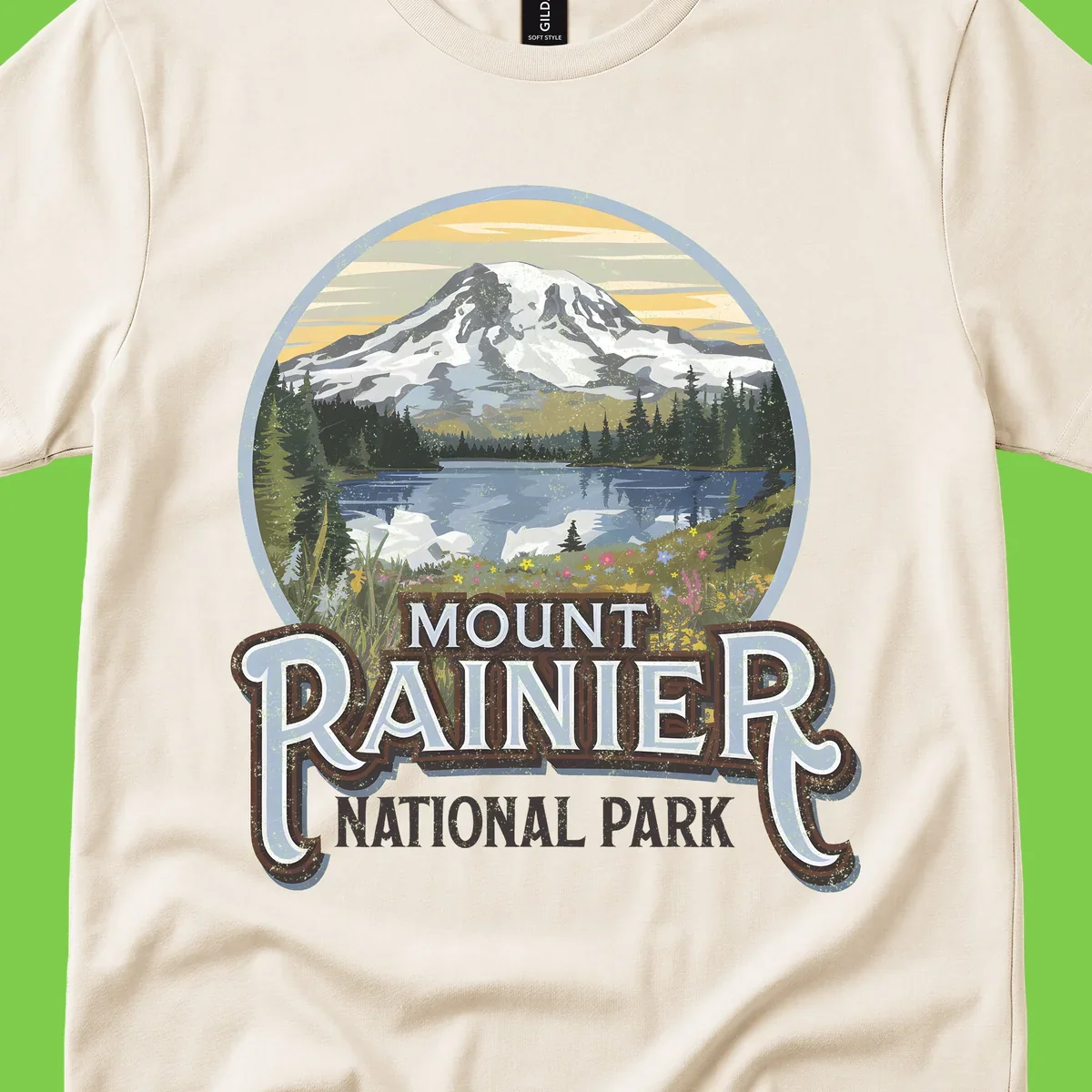 Vintage Mount Rainier National Park badge design with snow-capped peak, alpine lake, evergreen forest, and wildflowers on distressed background