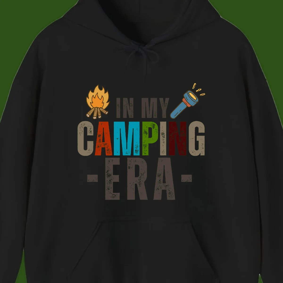 Campfire and flashlight icons flank colorful distressed text reading 'In My Camping Era' on gray background