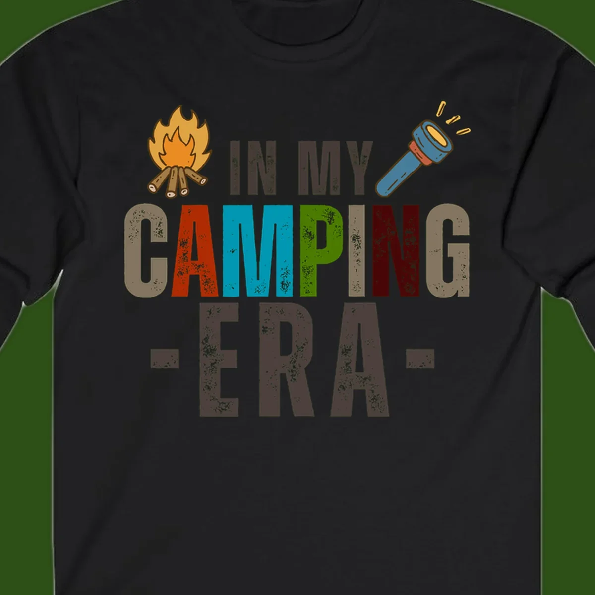 Campfire and flashlight icons flank colorful distressed text reading 'In My Camping Era' on gray background