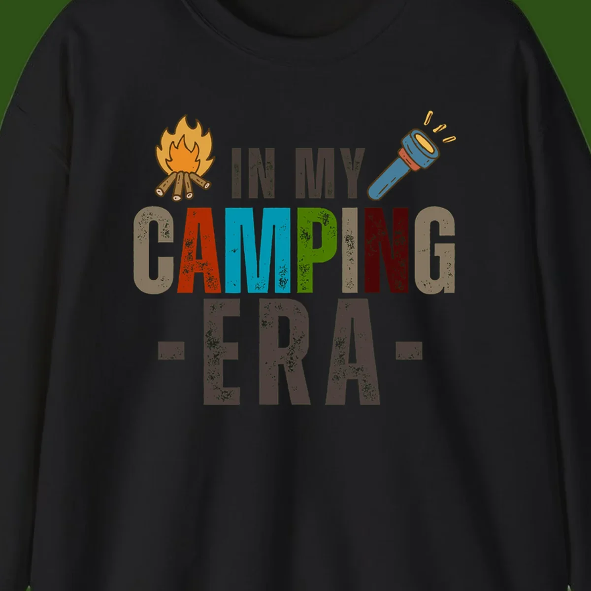 Campfire and flashlight icons flank colorful distressed text reading 'In My Camping Era' on gray background