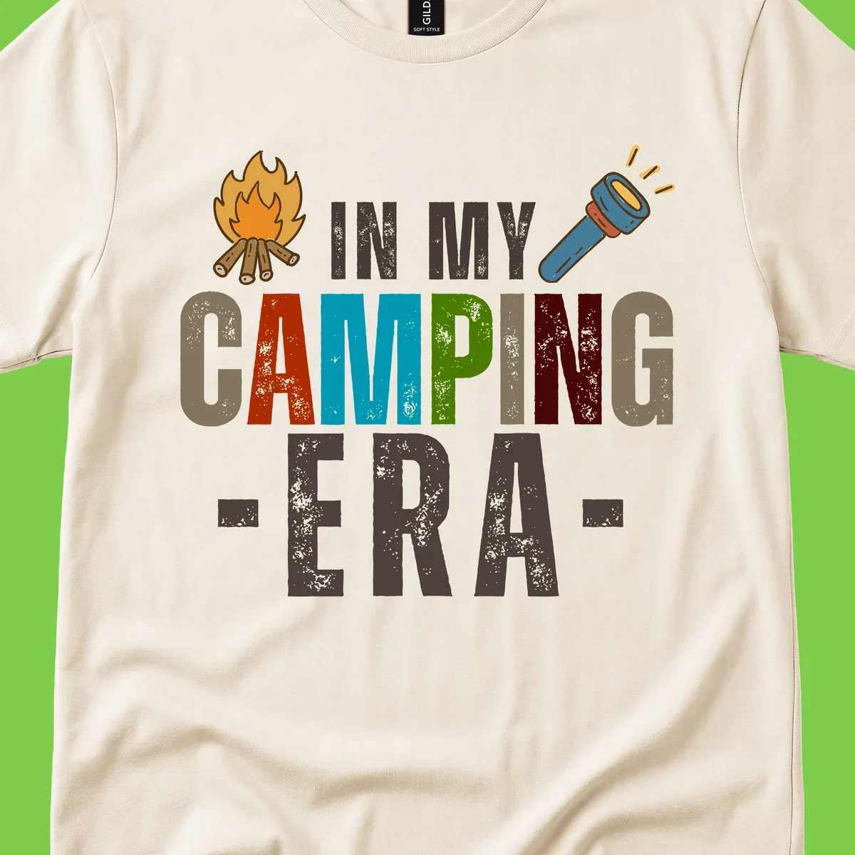 Campfire and flashlight icons flank colorful distressed text reading 'In My Camping Era' on gray background