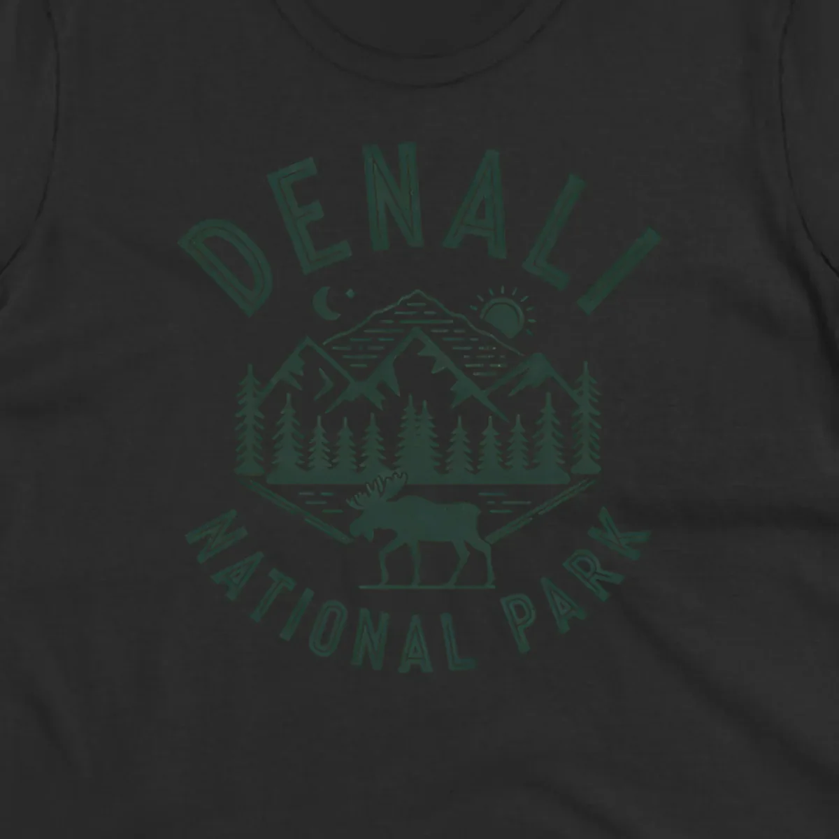 Denial National Park badge design with moose walking through forest, mountains, sun and moon with crossed fishing rods