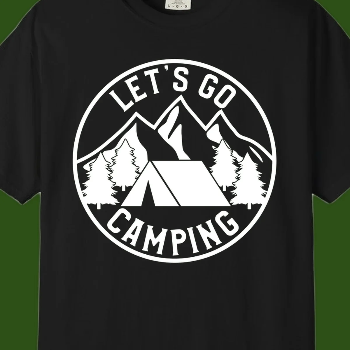 Circular let's go camping badge with tent, trees, and mountains in white and gray