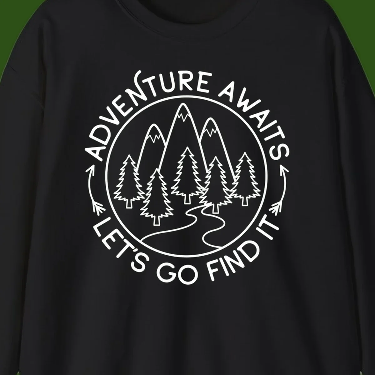 Circular badge with forest scene of evergreen trees and mountains, text reads 'Adventure Awaits Let's Go Find It'