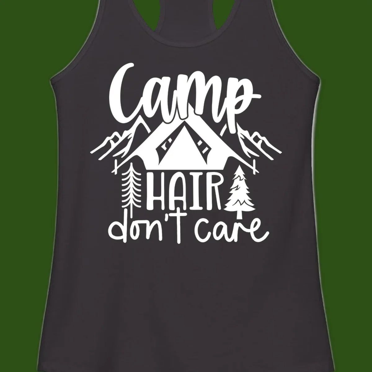 Camp hair don't care design with tent, mountains, pine trees, and campfire illustration with cursive text